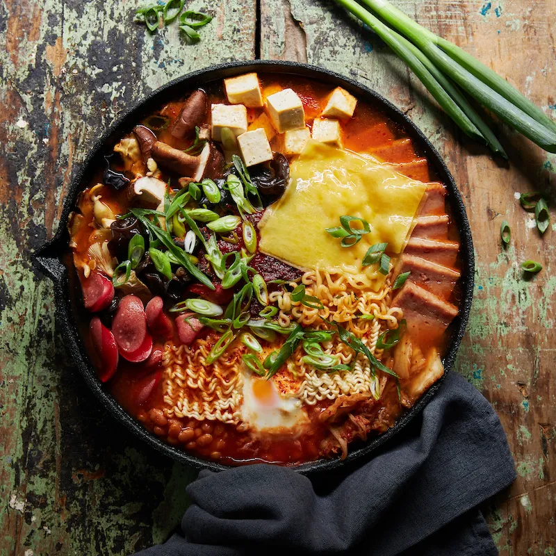 A bowl of food with a fork and a knife.