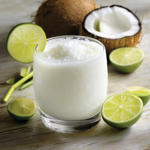 A glass of milk with a slice of lime on the side.