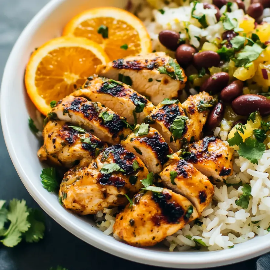A bowl of chicken with rice and beans.
