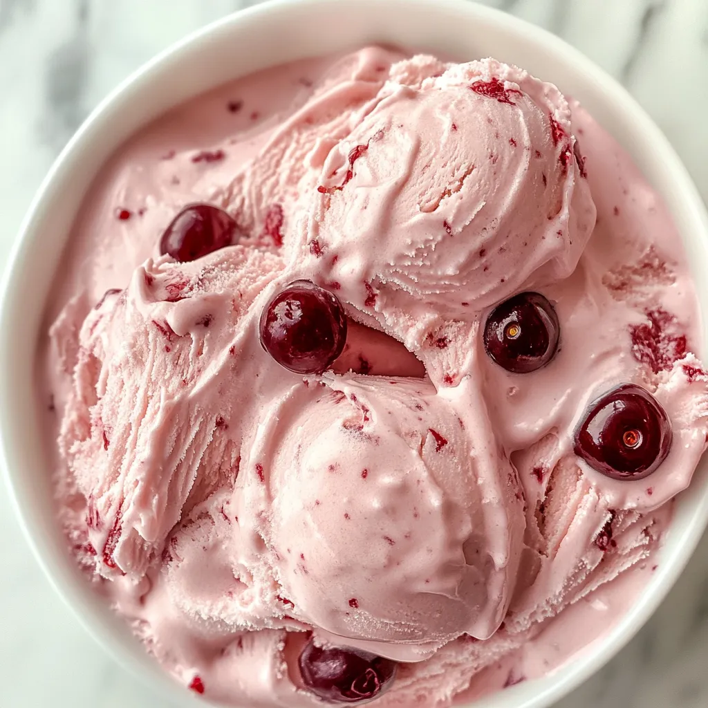 A bowl of pink ice cream with cherries on top.