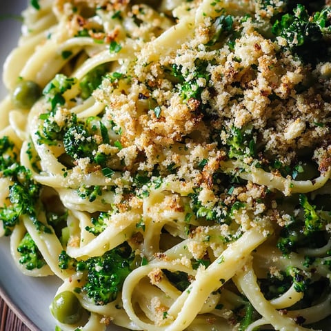 A plate of pasta with broccoli and cheese.