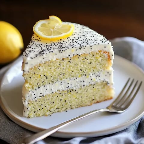 A single slice of cake with fresh mint and lemon garnish.