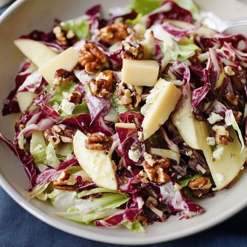 A delicious salad featuring apples and walnuts.