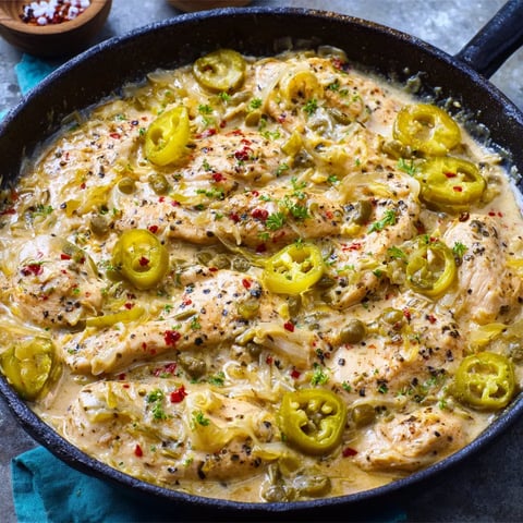 A pan of food with chicken and peppers.