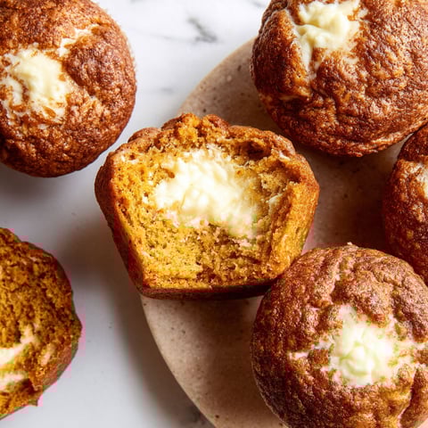 A plate of pumpkin cream cheese muffins.